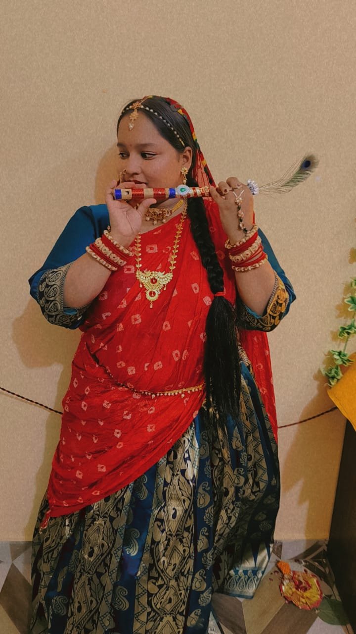 Performer in a red and blue traditional costume