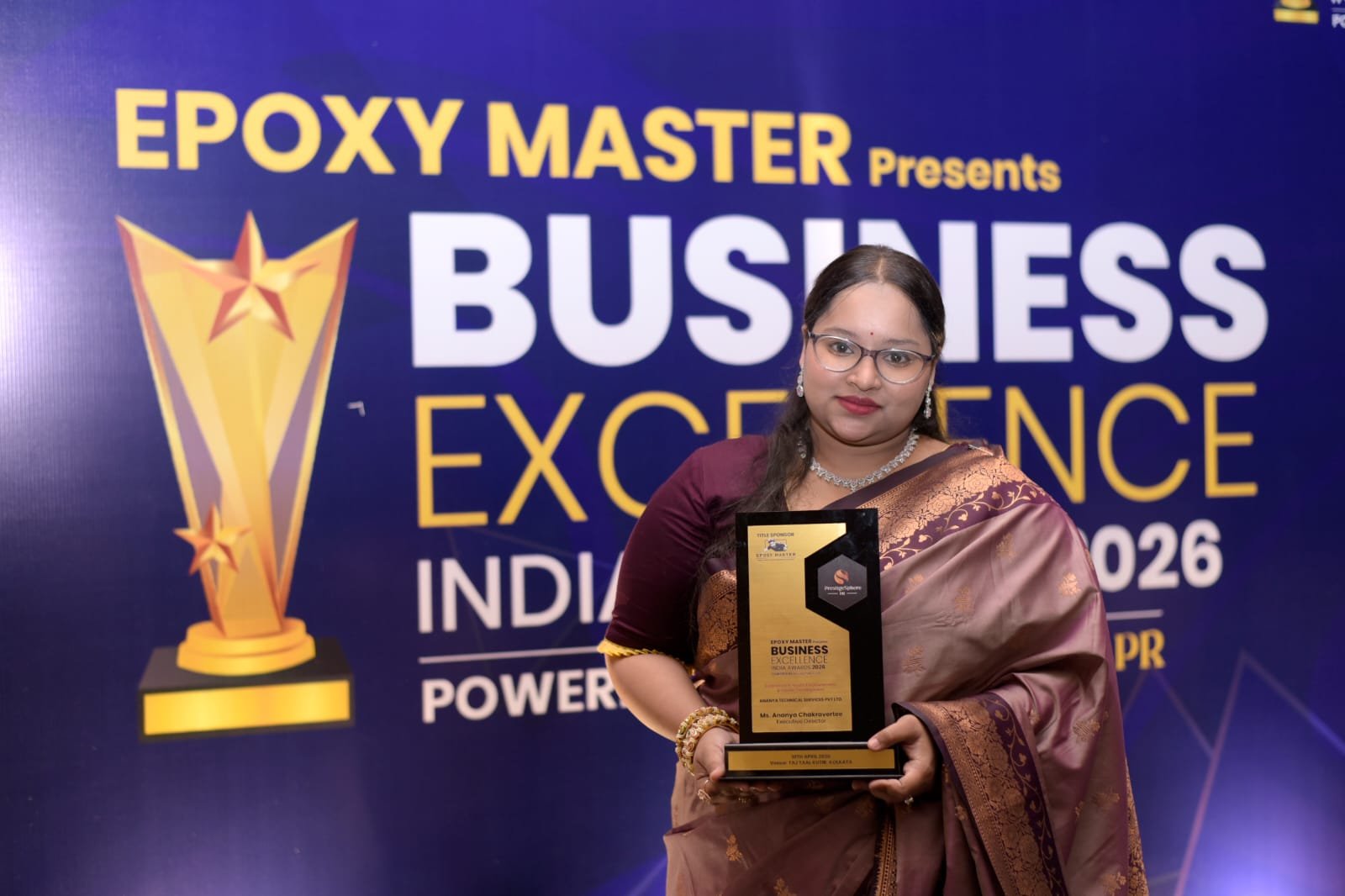 Award recipient holding a trophy